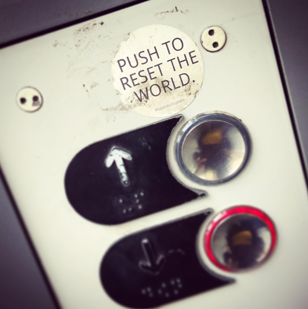 Push to reset the world, sticker art in an elevator (Antwerp, BE).